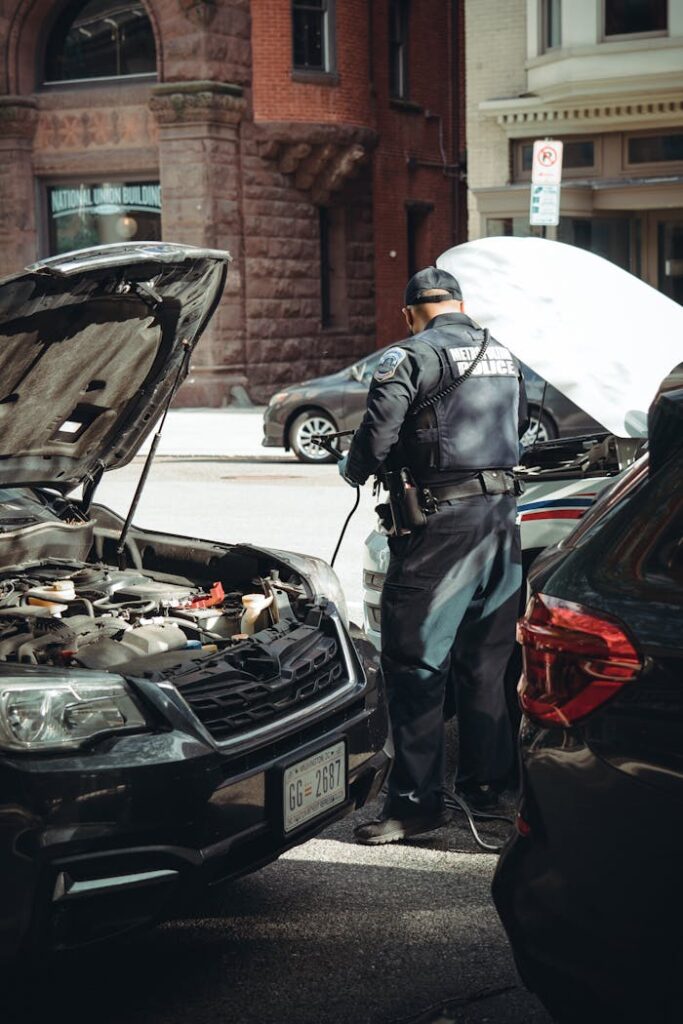 Police Officer Recharging Car on City Street